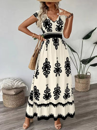 Green printed V-neck dress by Trendsi featuring ruffled cap sleeves and a flowy, feminine design.