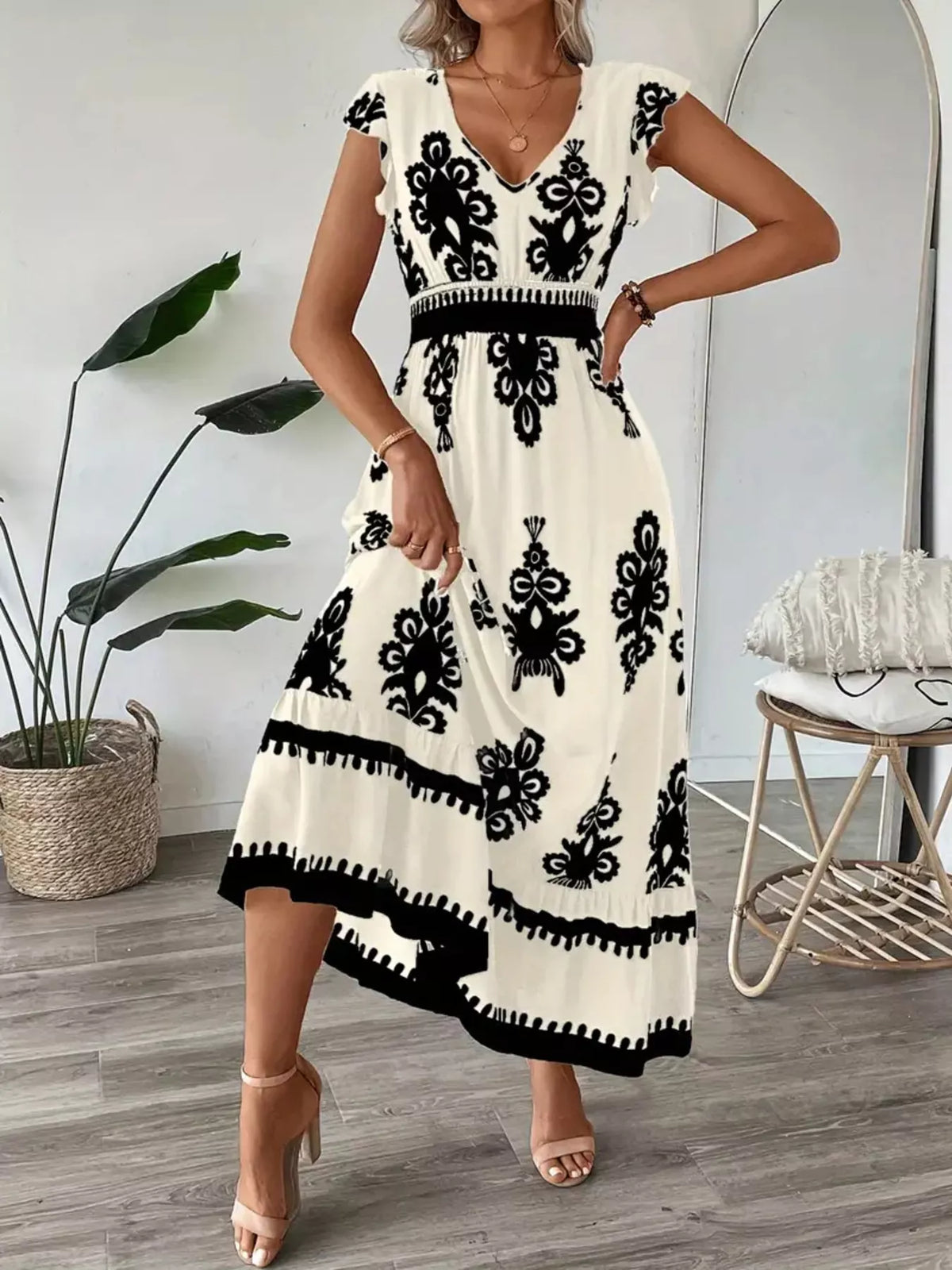 Green printed V-neck dress with ruffled cap sleeves by Trendsi, featuring a stylish and feminine design.