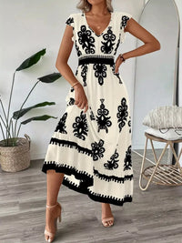 Green printed V-neck dress with ruffled cap sleeves by Trendsi, featuring a stylish and feminine design.