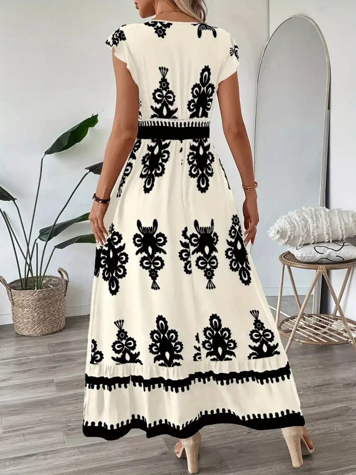 Green printed V-neck dress with ruffled cap sleeves by Trendsi, featuring a stylish and feminine design.