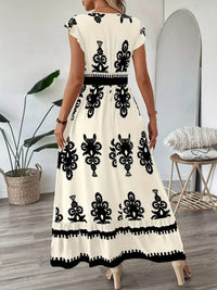 Green printed V-neck dress with ruffled cap sleeves by Trendsi, featuring a stylish and feminine design.