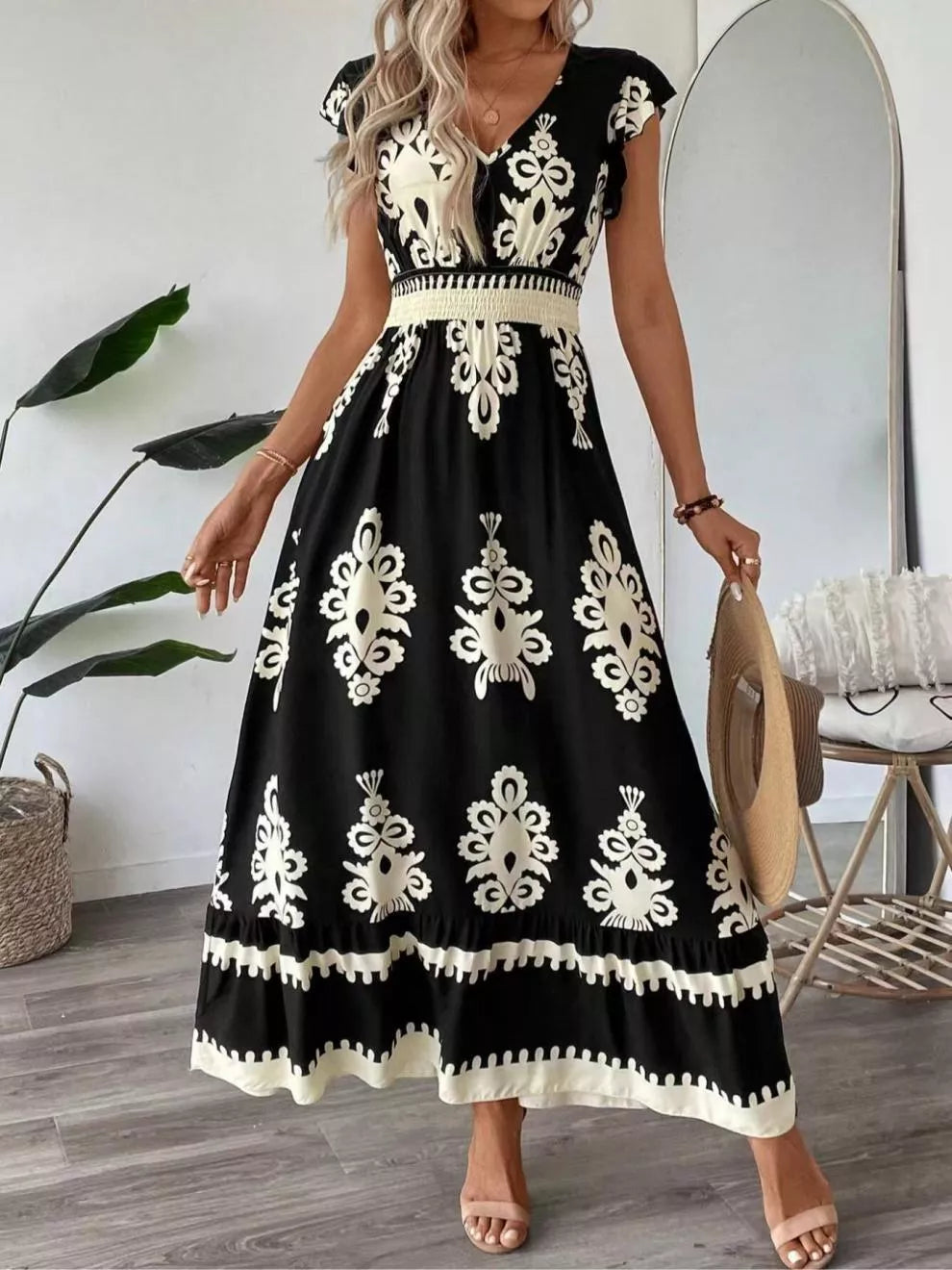 Green printed V-neck dress by Trendsi with ruffled cap sleeves, lightweight fabric, perfect for casual or semi-formal occasions.