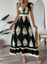 Green printed V-neck dress with ruffled cap sleeves by Trendsi, featuring a stylish and feminine design perfect for casual wear.