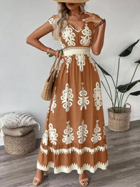 Green printed V-neck dress by Trendsi featuring ruffled cap sleeves and a flowing, elegant silhouette.