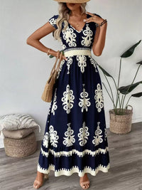 Green printed V-neck dress with ruffled cap sleeves by Trendsi, shown on a model with a flowy, feminine silhouette.