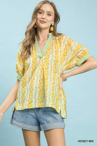 Mix print boho blouse with contrast trim, featuring relaxed fit and vibrant patterns, perfect for casual and stylish looks.