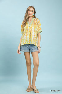 Boho blouse with mix print and contrast trim by Trendsi, featuring a relaxed fit and stylish, colorful design.