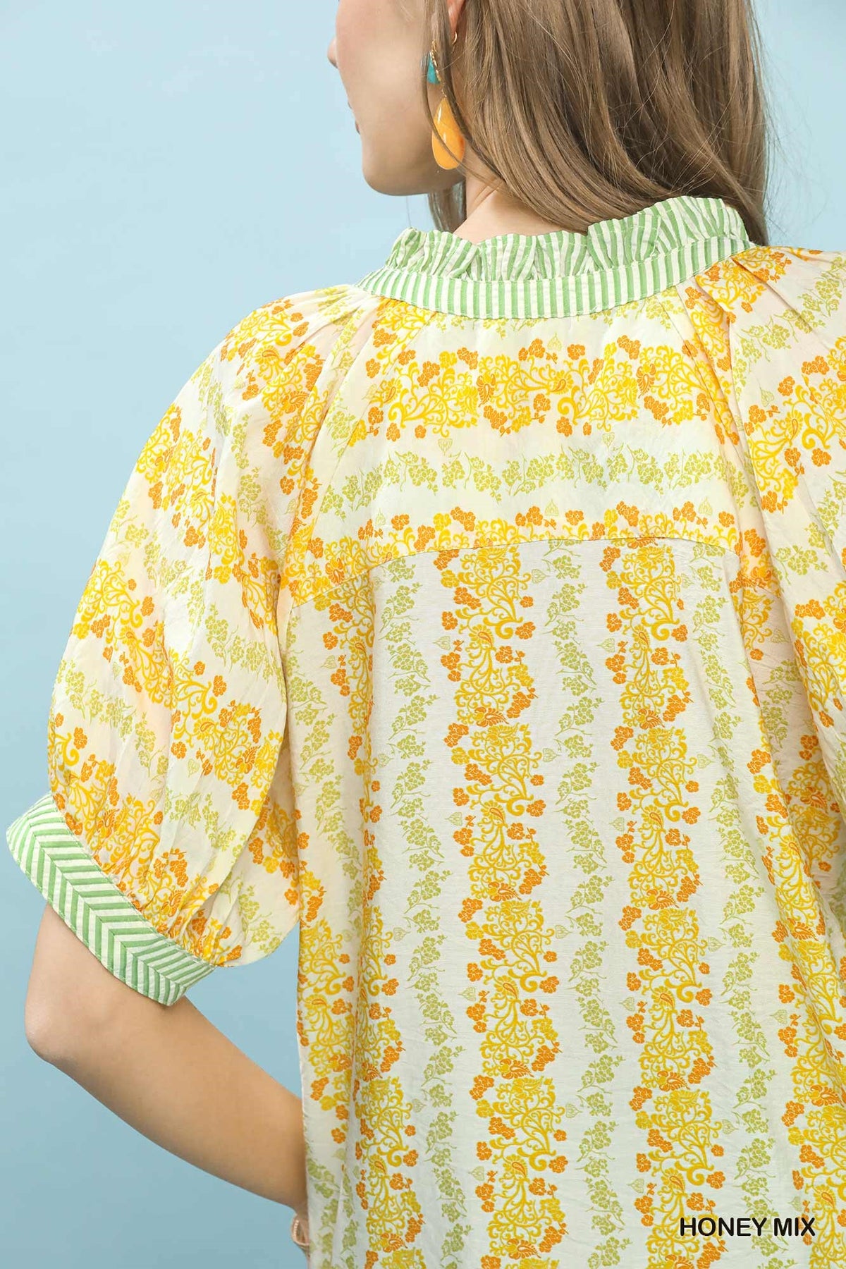 Boho blouse with mixed print and contrast trim from Trendsi, featuring flowy fabric and stylish bohemian design.