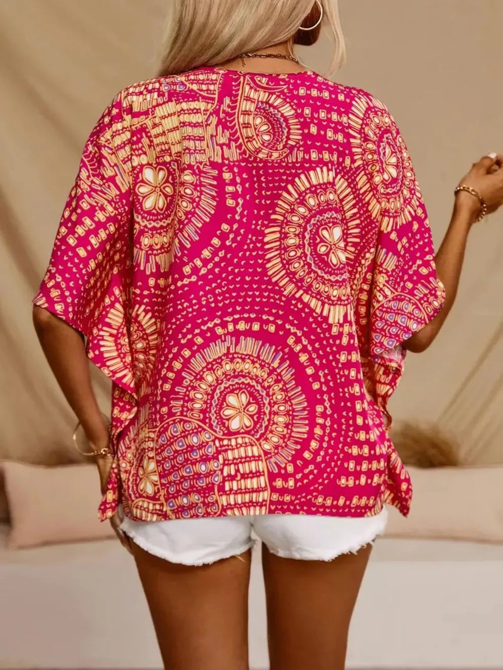Hot pink printed V-neck half sleeve top from Trendsi, showing close-up of fabric and stylish design.