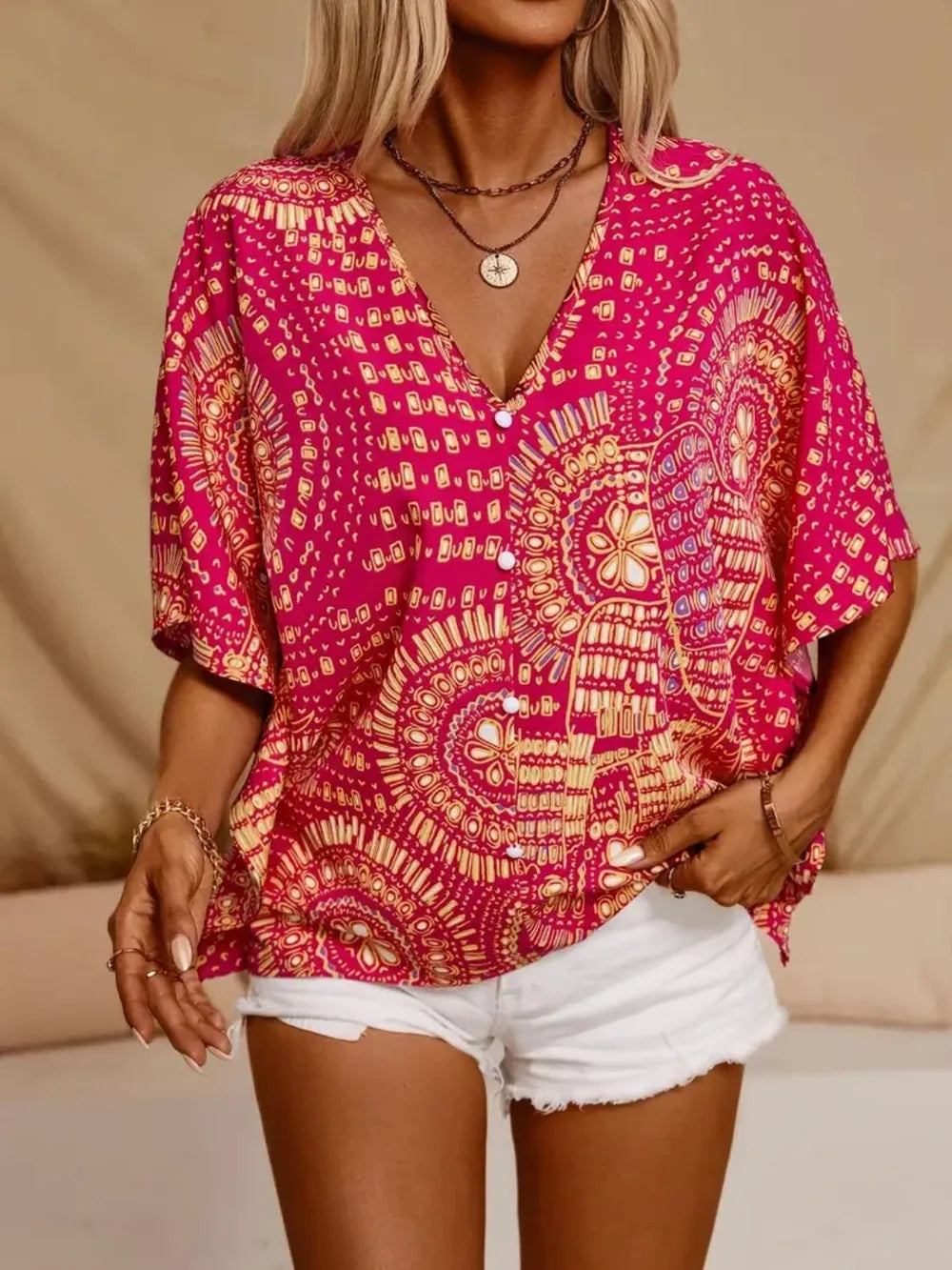 Hot pink printed V-neck half sleeve top from Trendsi, showcasing a stylish, casual women's fashion top with vibrant pattern.