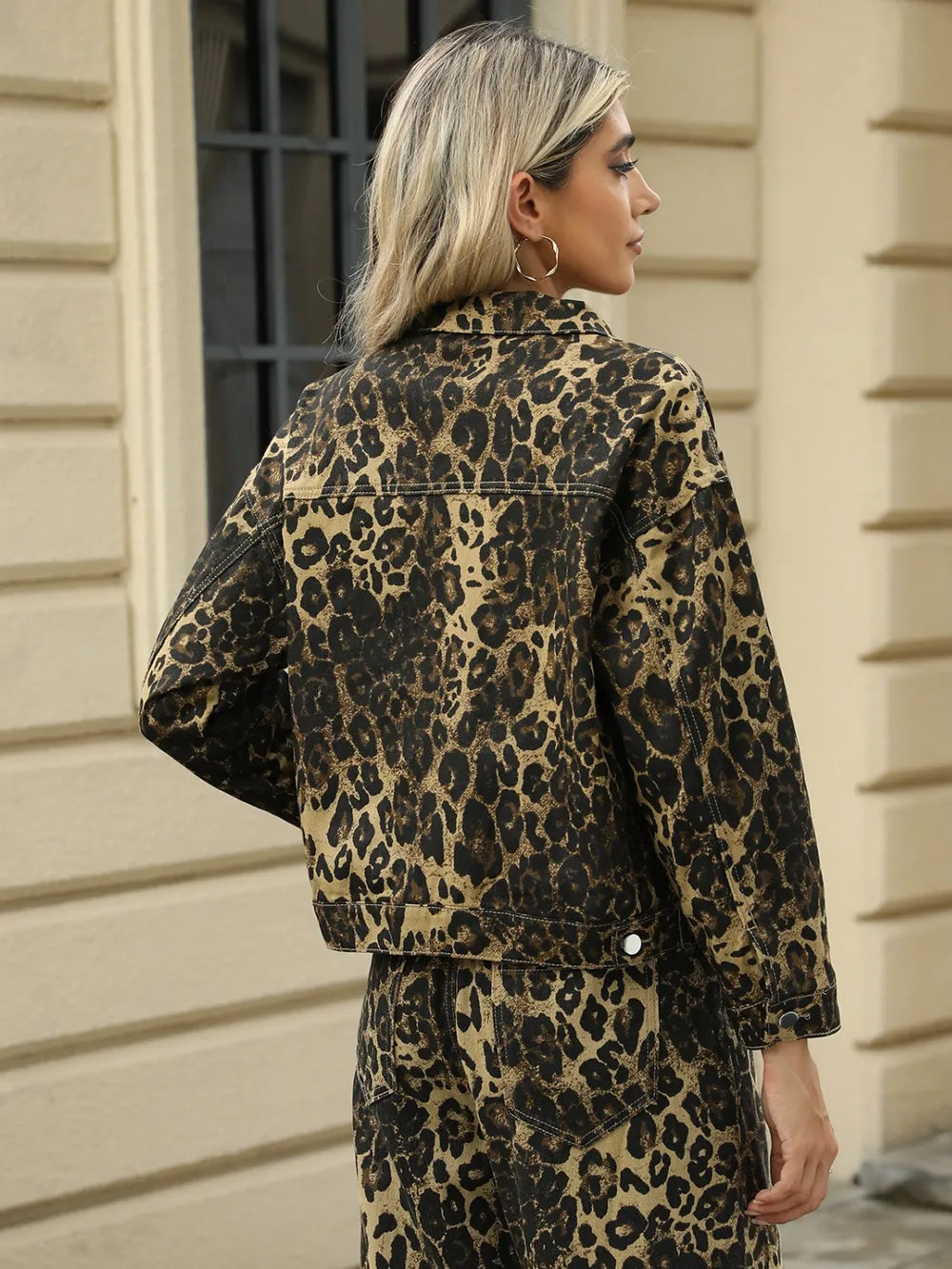 Leopard print long sleeve denim jacket with front pockets from Trendsi, featuring a stylish pocketed design and leopard pattern.