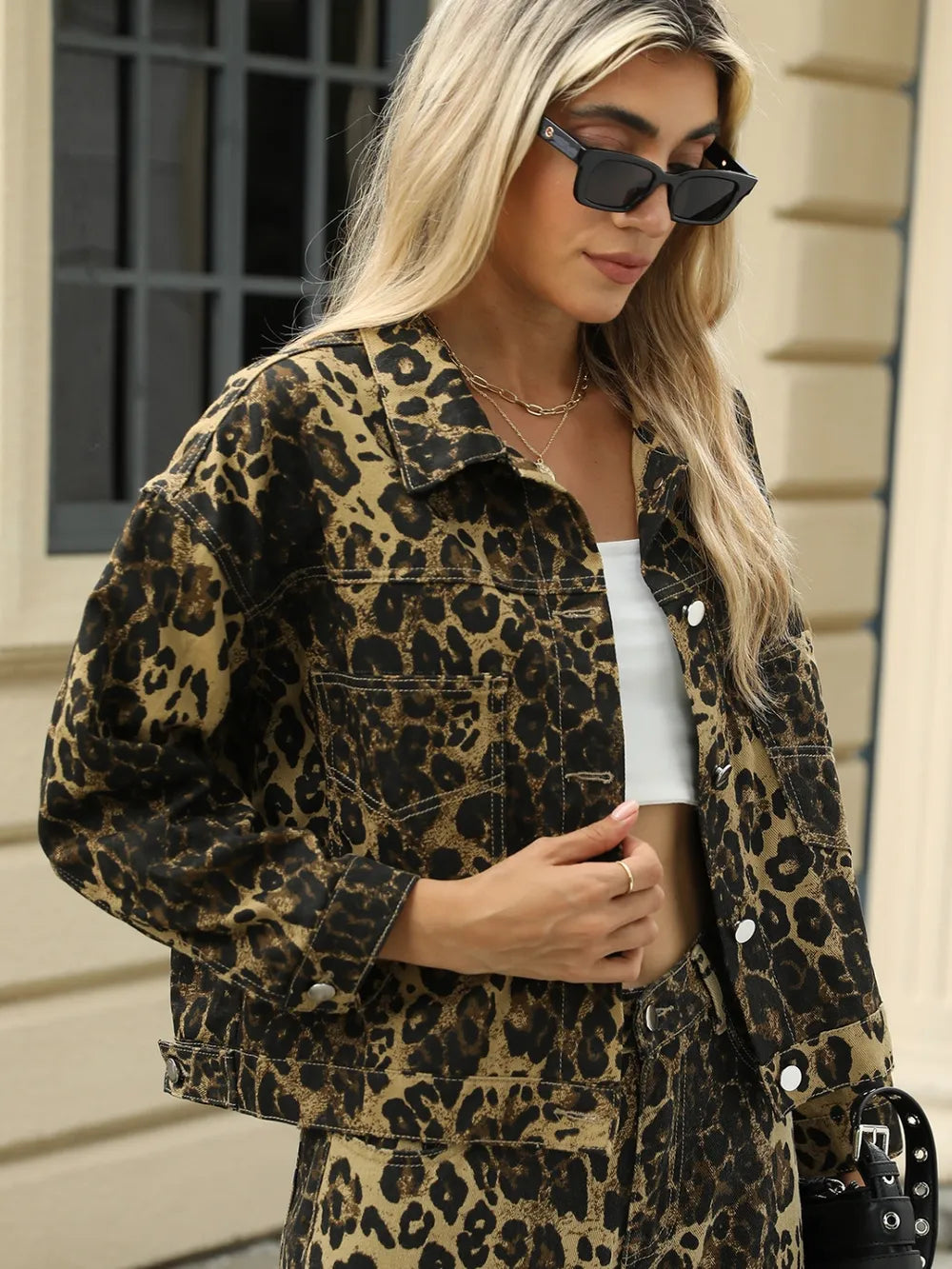 Leopard print long sleeve denim jacket with front pockets by Trendsi, featuring a stylish and casual design.
