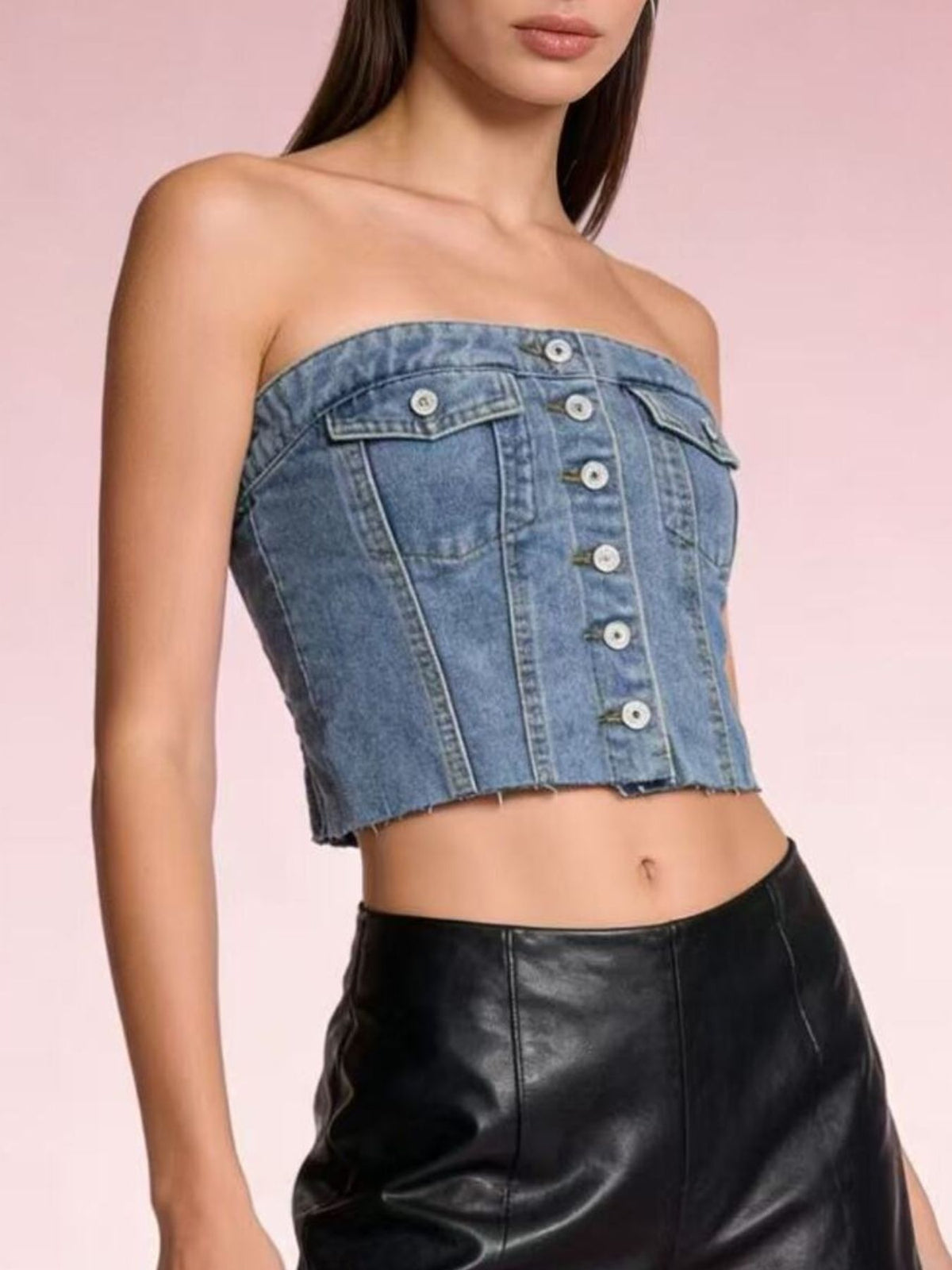 Light blue button-front strapless denim top by Trendsi, showcasing a fitted sleeveless design with front buttons and adjustable straps.
