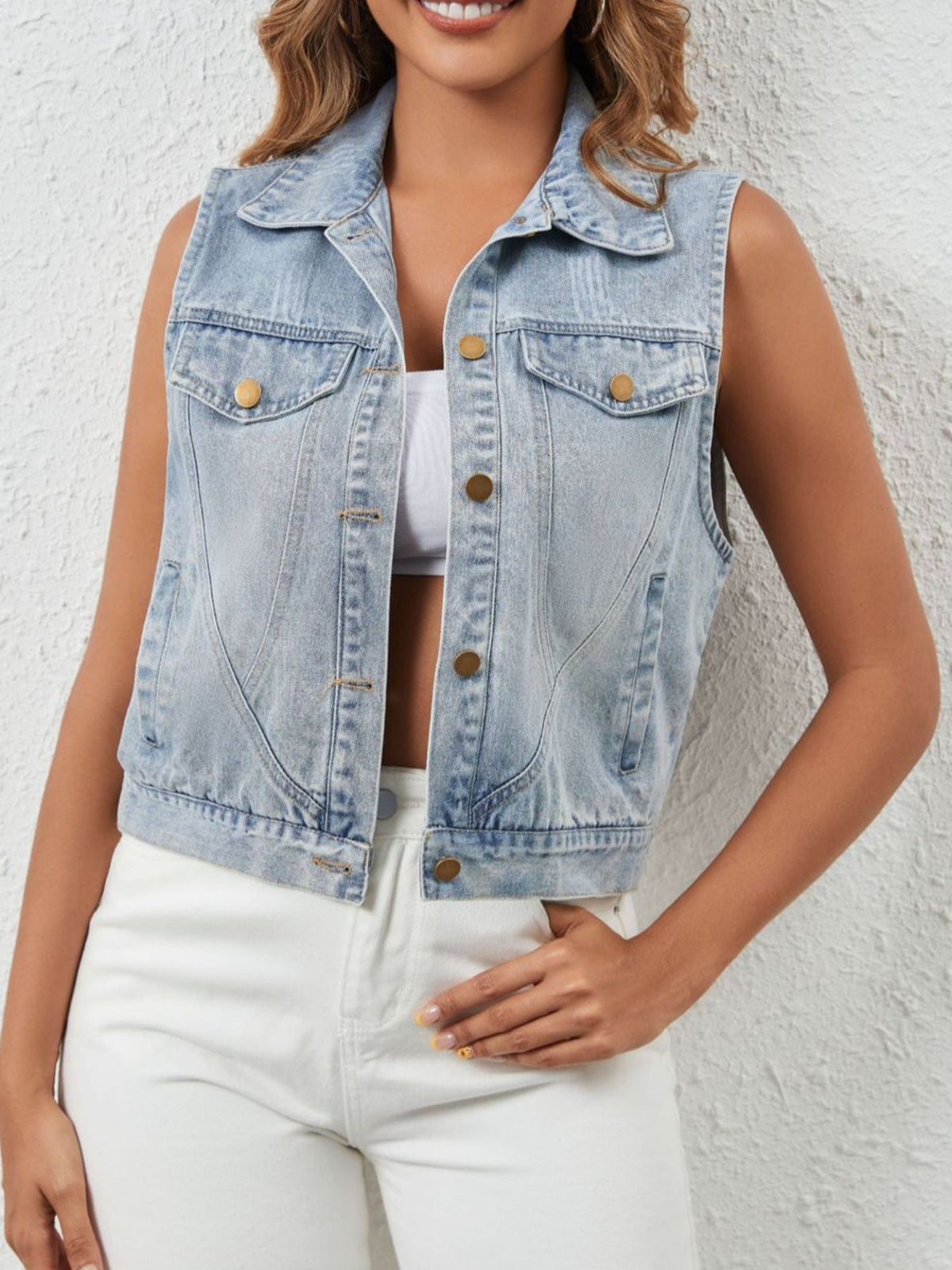 Light blue sleeveless denim jacket by Trendsi with button-up front, casual sleeveless design, and classic denim texture.