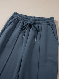 Light gray collared sweatshirt and high-waist pants active set by Trendsi, casual athletic wear for women.