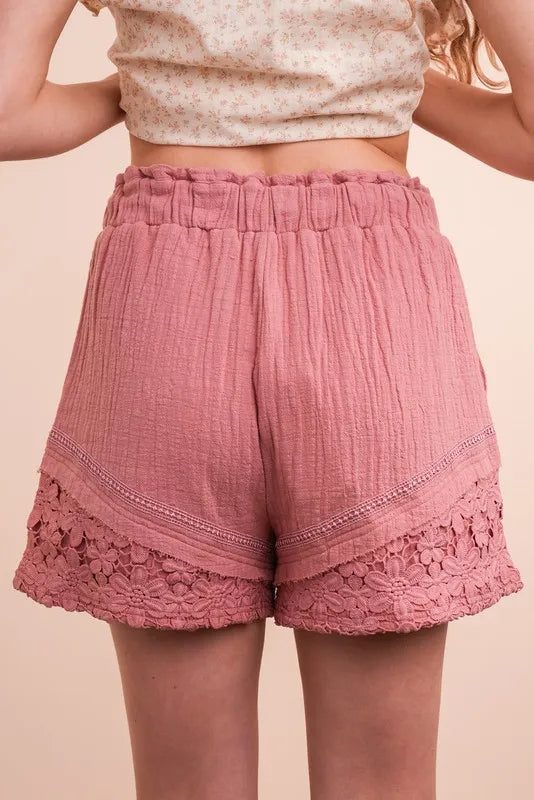 Lace contrast detail woven shorts by Trendsi featuring a stylish design with lace accents and a relaxed fit.