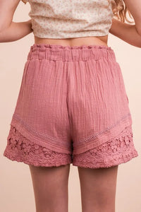 Lace contrast detail woven shorts by Trendsi featuring a stylish design with lace accents and a relaxed fit.