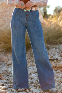 High-waisted wide-leg button-front jeans from Trendsi, featuring classic denim with a relaxed fit and stylish design.