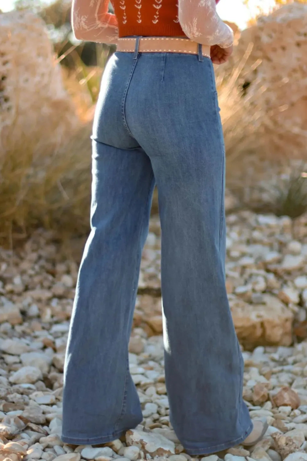 High-waisted wide-leg button-front jeans by Trendsi, showing denim fabric, high waist, and relaxed fit with front buttons.