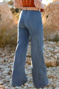 High-waisted wide-leg button-front jeans by Trendsi, showing denim fabric, high waist, and relaxed fit with front buttons.