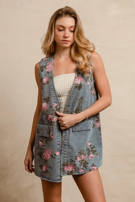 BiBi floral print washed denim long rider vest by Trendsi displayed on a mannequin, showcasing floral details and distressed denim fabric.