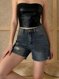 Distressed slit denim shorts by Trendsi featuring a casual fit, frayed edges, and distressed details on light-wash denim.