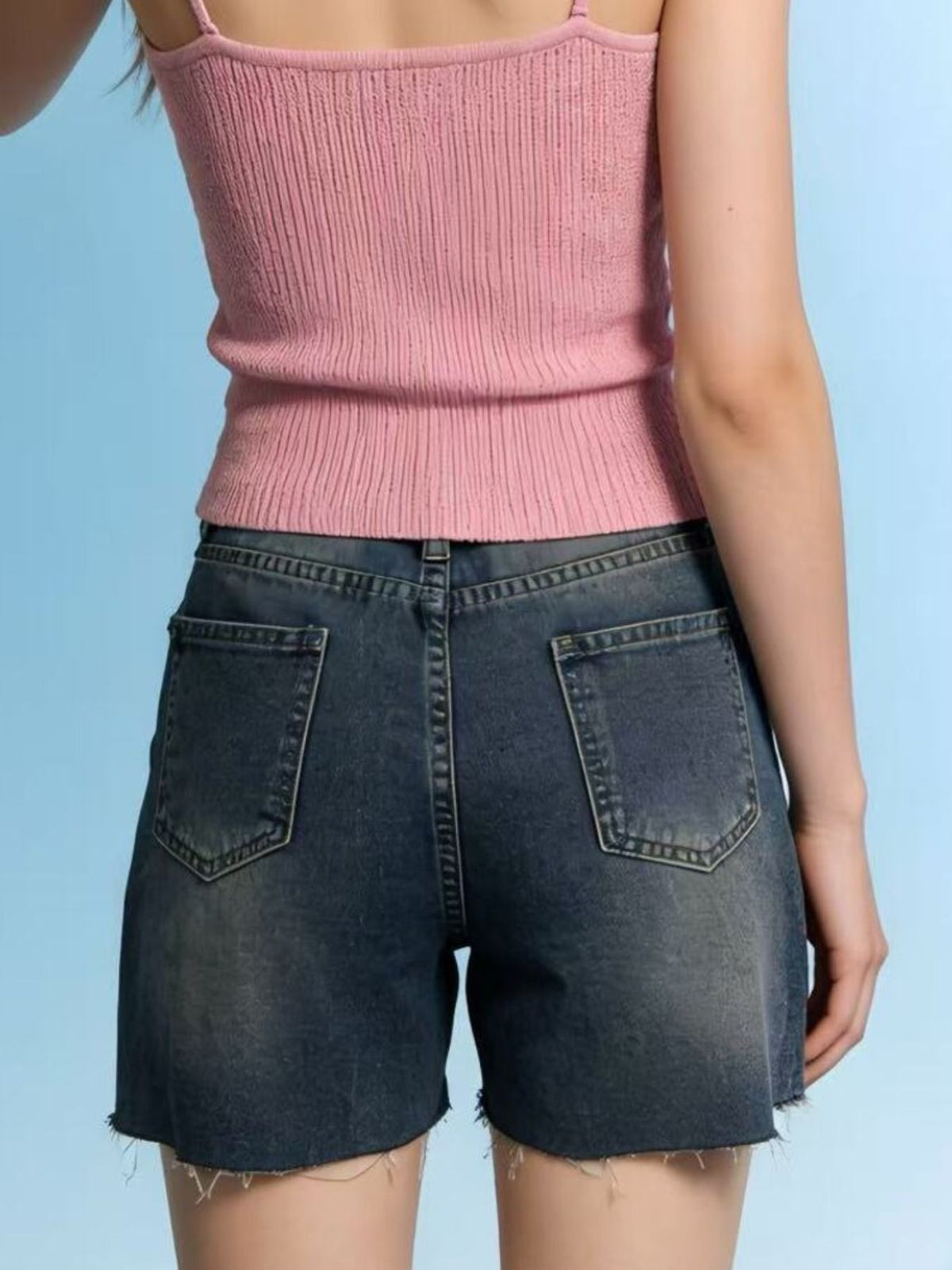Distressed slit denim shorts by Trendsi featuring frayed edges and a casual fit, shown on a model.
