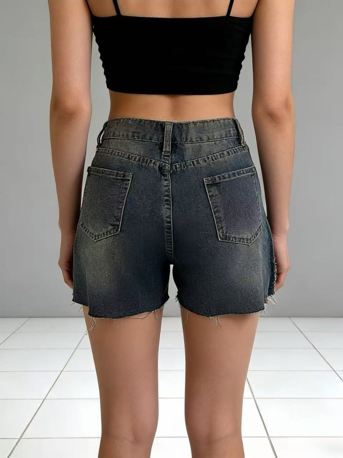 Distressed slit denim shorts from Trendsi featuring frayed edges and a casual, trendy fit.