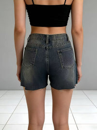 Distressed slit denim shorts from Trendsi featuring frayed edges and a casual, trendy fit.