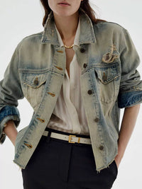 Distressed wash button-up denim jacket by Trendsi featuring a classic fit, frayed details, and casual style.