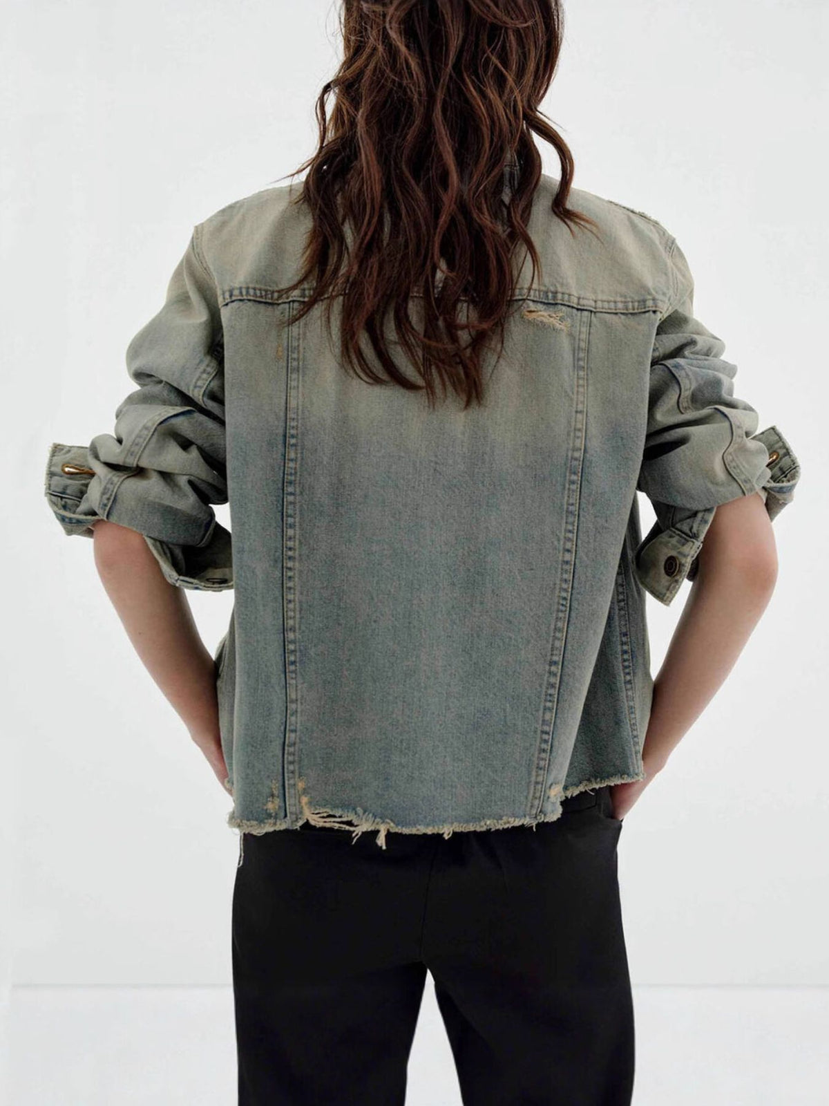 Distressed wash button-up denim jacket by Trendsi, featuring a rugged look, classic collar, and front button closure.