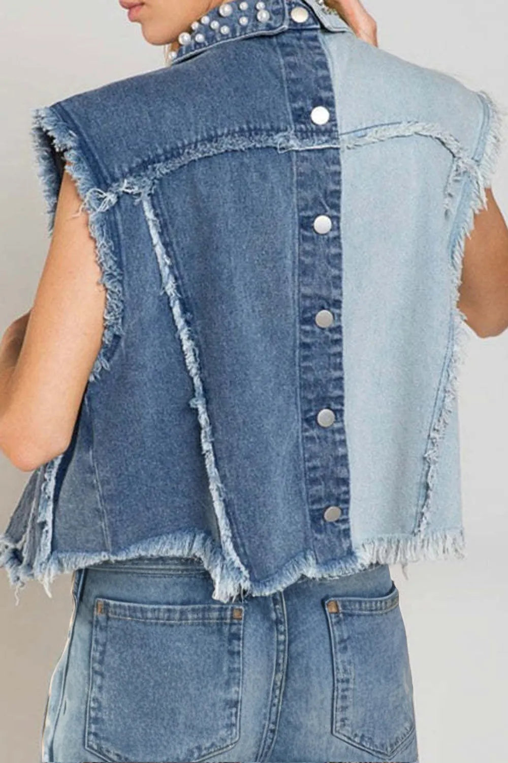 Pearl raw hem sleeveless denim jacket by Trendsi, featuring classic blue denim with pearl accents and a casual sleeveless design.