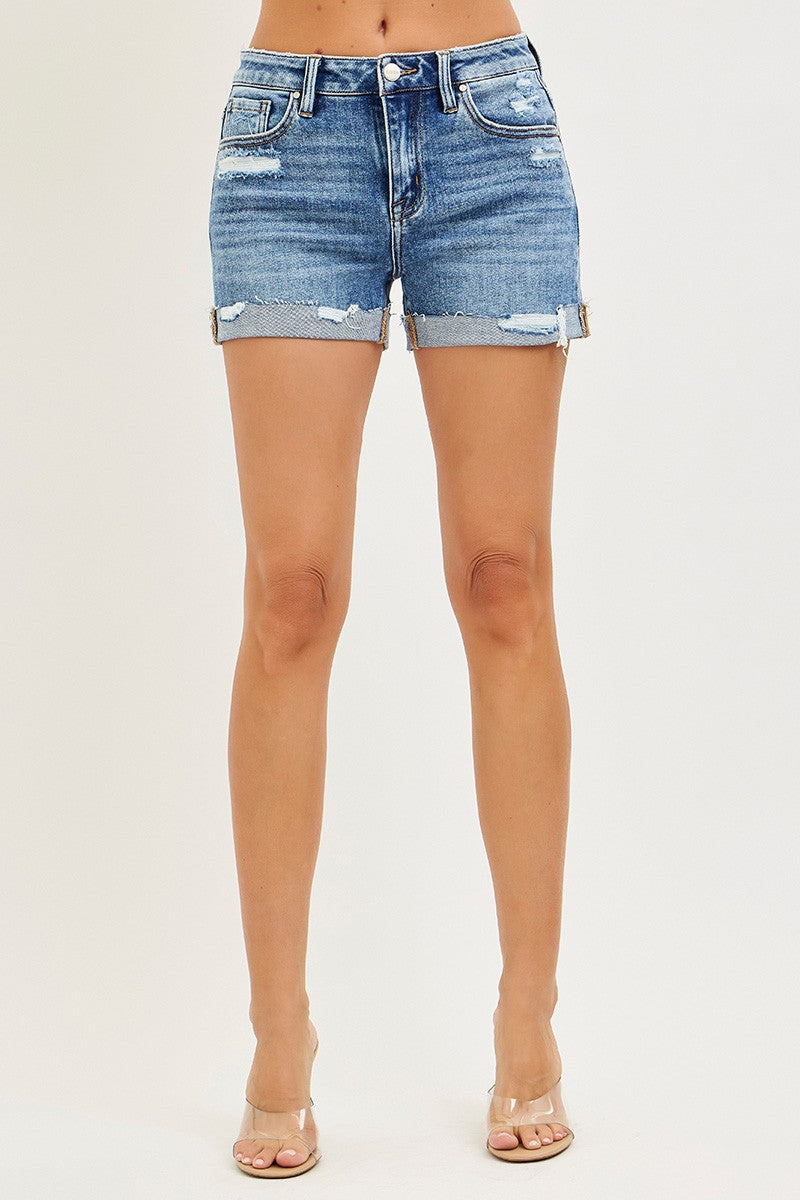 Risen mid-rise cuffed shorts in denim with rolled hem, fitted style, shown on a model with casual summer outfit