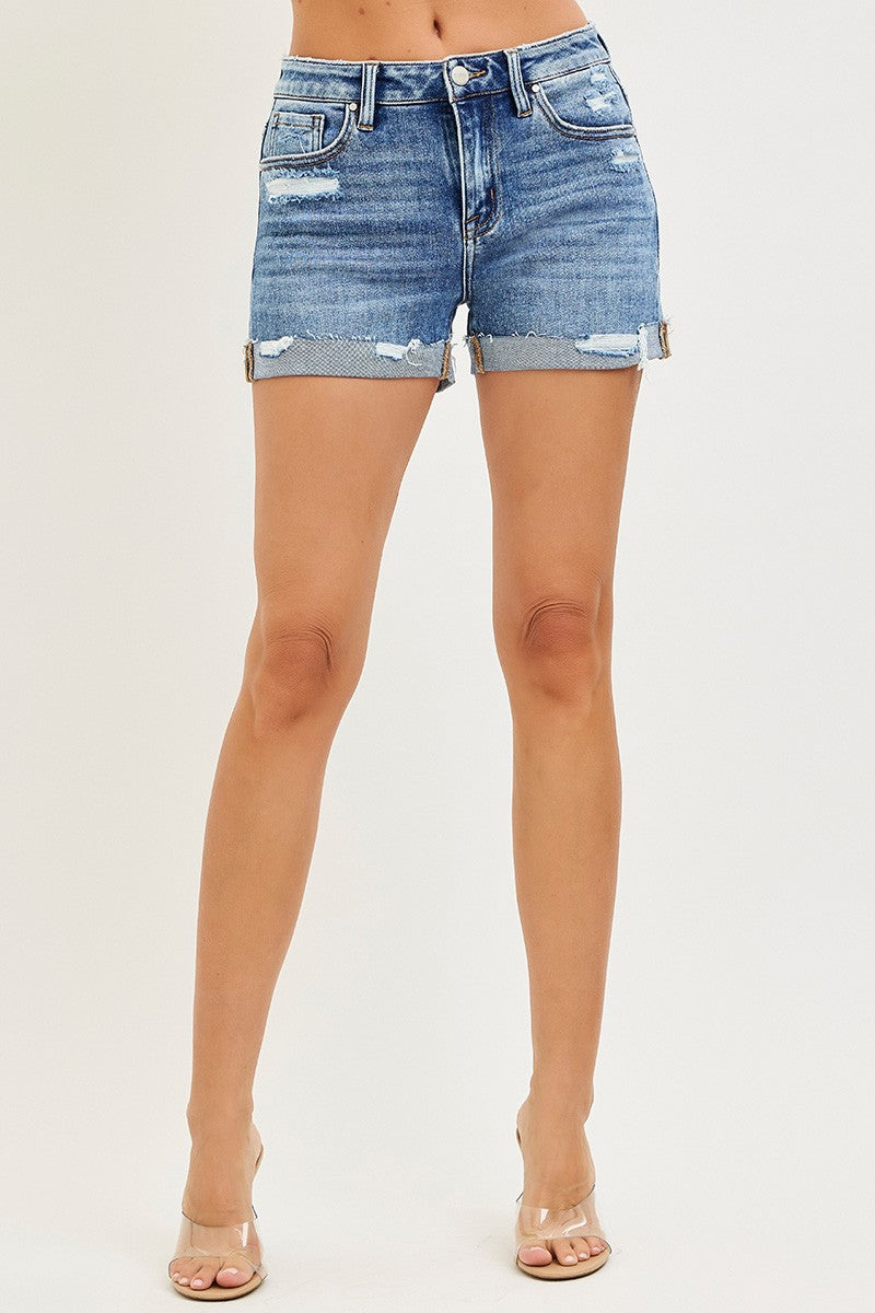 Light blue RISEN mid-rise cuffed shorts with rolled hems, styled casually on a model for a trendy summer look.