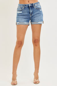 Light blue RISEN mid-rise cuffed shorts with rolled hems, styled casually on a model for a trendy summer look.