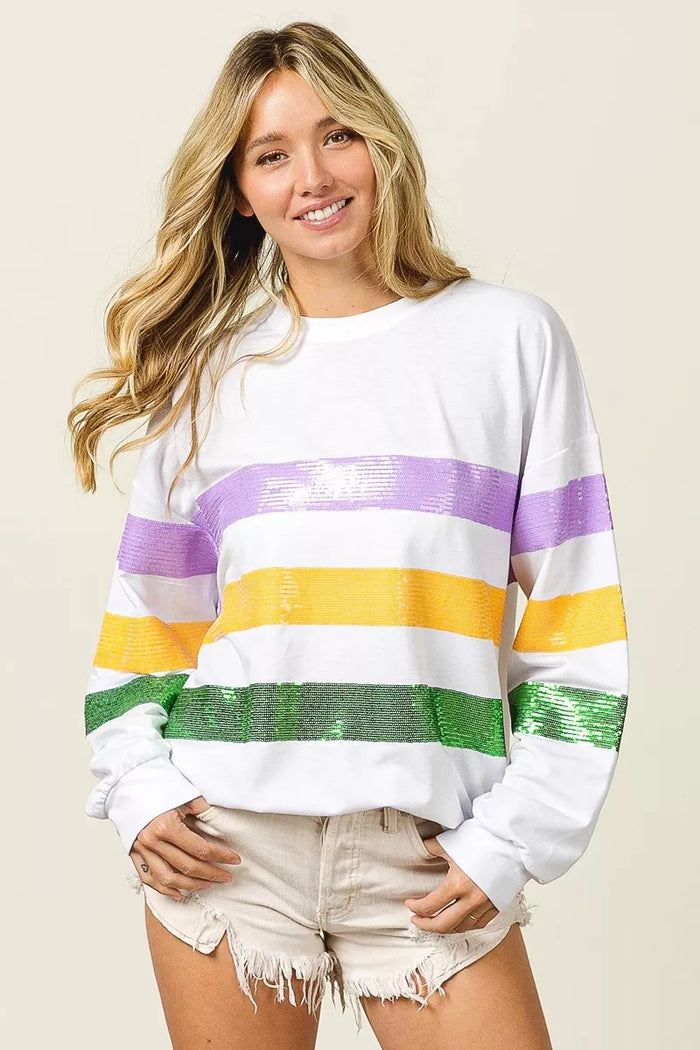 Sequin Mardi Gras striped round neck sweatshirt by Trendsi featuring colorful sequins and a casual fit.