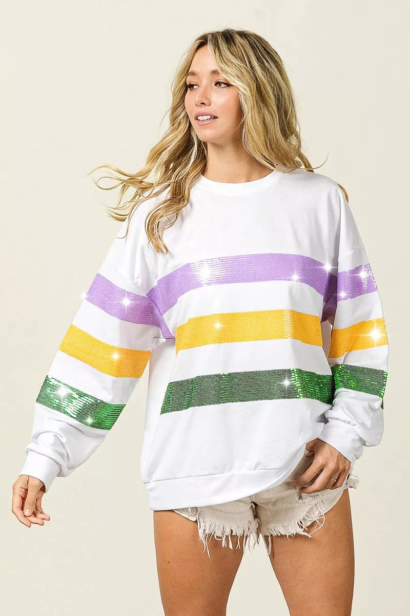 BiBi Sequin Mardi Gras striped round neck sweatshirt by Trendsi with vibrant sequin details and comfortable fit.