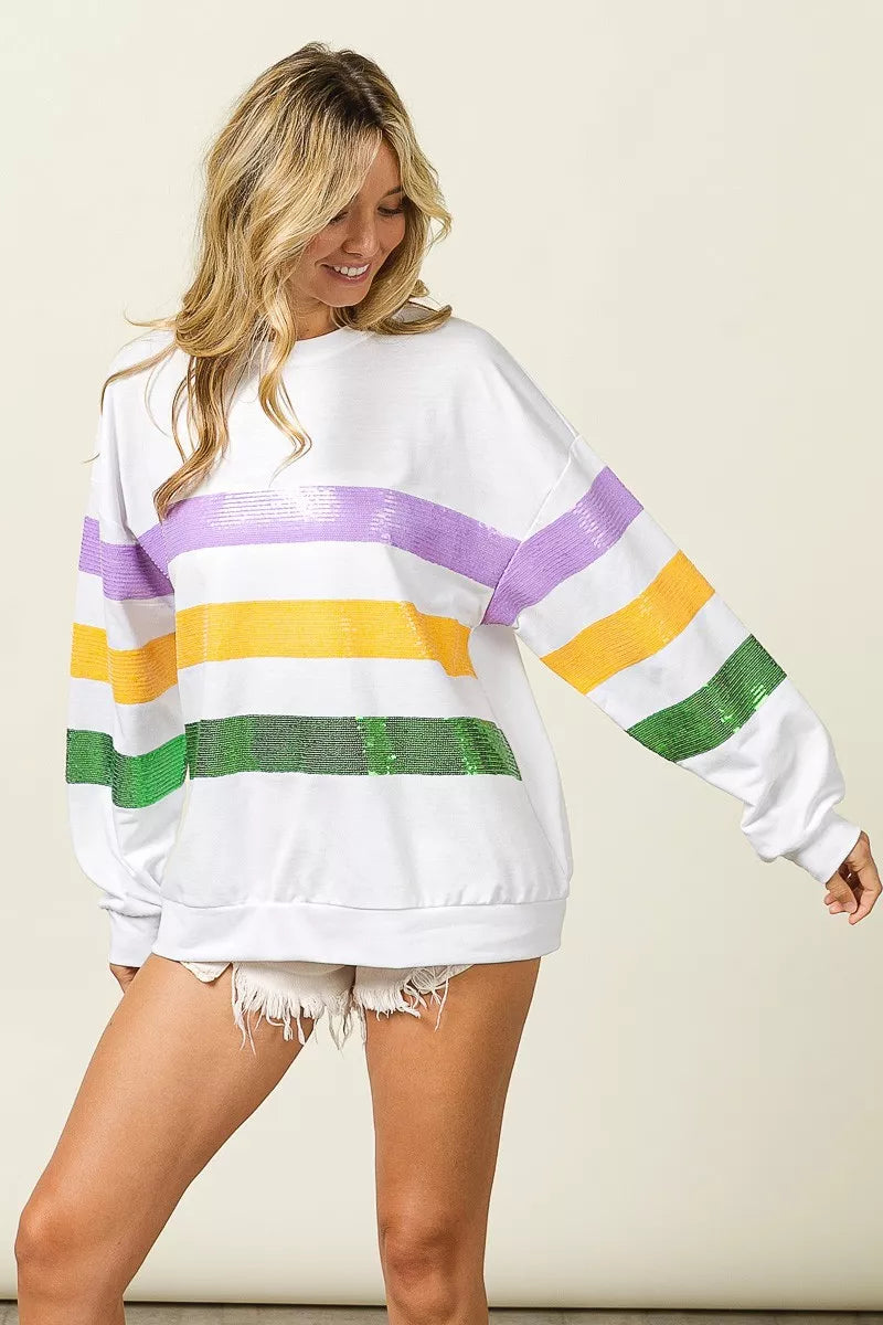 Sequin Mardi Gras striped round neck sweatshirt by Trendsi featuring bold colors and festive design with sequined accents.