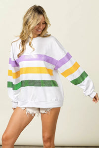 Sequin Mardi Gras striped round neck sweatshirt by Trendsi featuring bold colors and festive design with sequined accents.