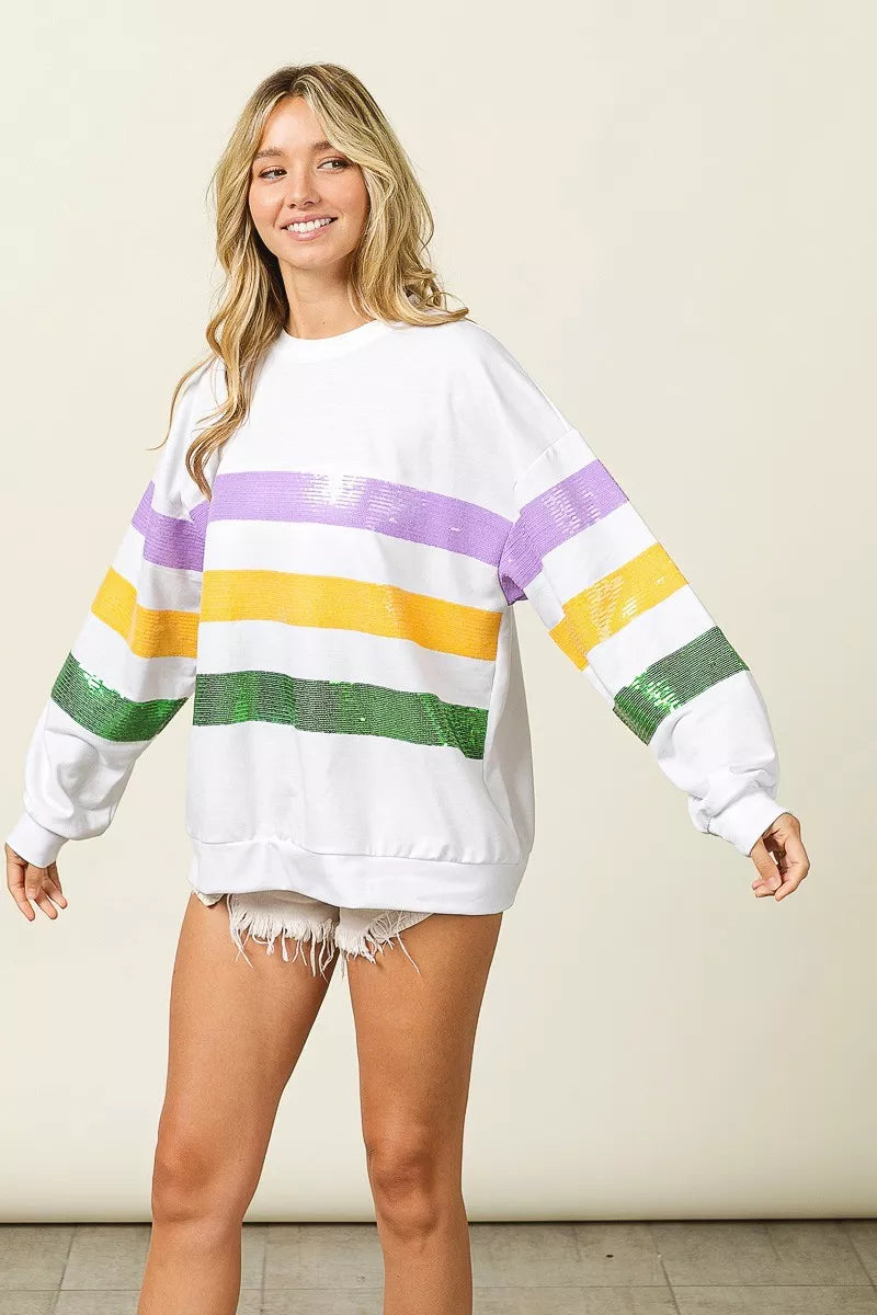 Sequin Mardi Gras striped round neck sweatshirt by Trendsi featuring vibrant colors and a comfortable fit.