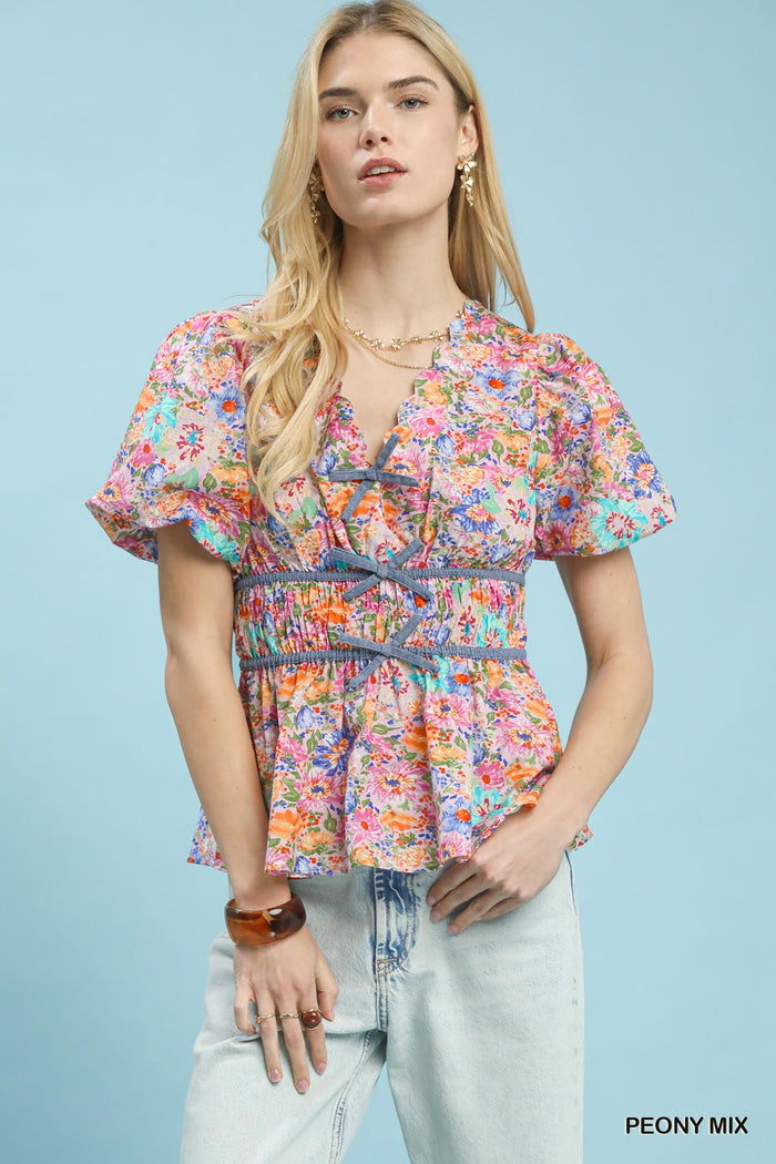Umgee floral smocked waist blouse featuring a mix of colorful floral patterns and a relaxed, feminine fit.