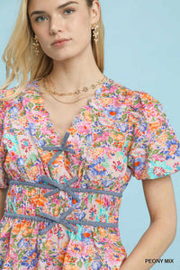 Umgee floral smocked waist blouse with mixed floral pattern and flowy fabric, shown on a model.