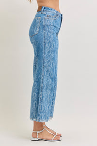 Judy Blue high-rise ankle wide-leg jeans with distressed details, denim fabric, and a relaxed fit, styled for casual wear.
