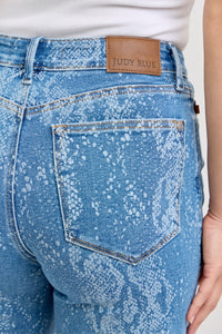 Judy Blue high-rise ankle wide-leg jeans with distressed details and classic denim wash, styled on a model.