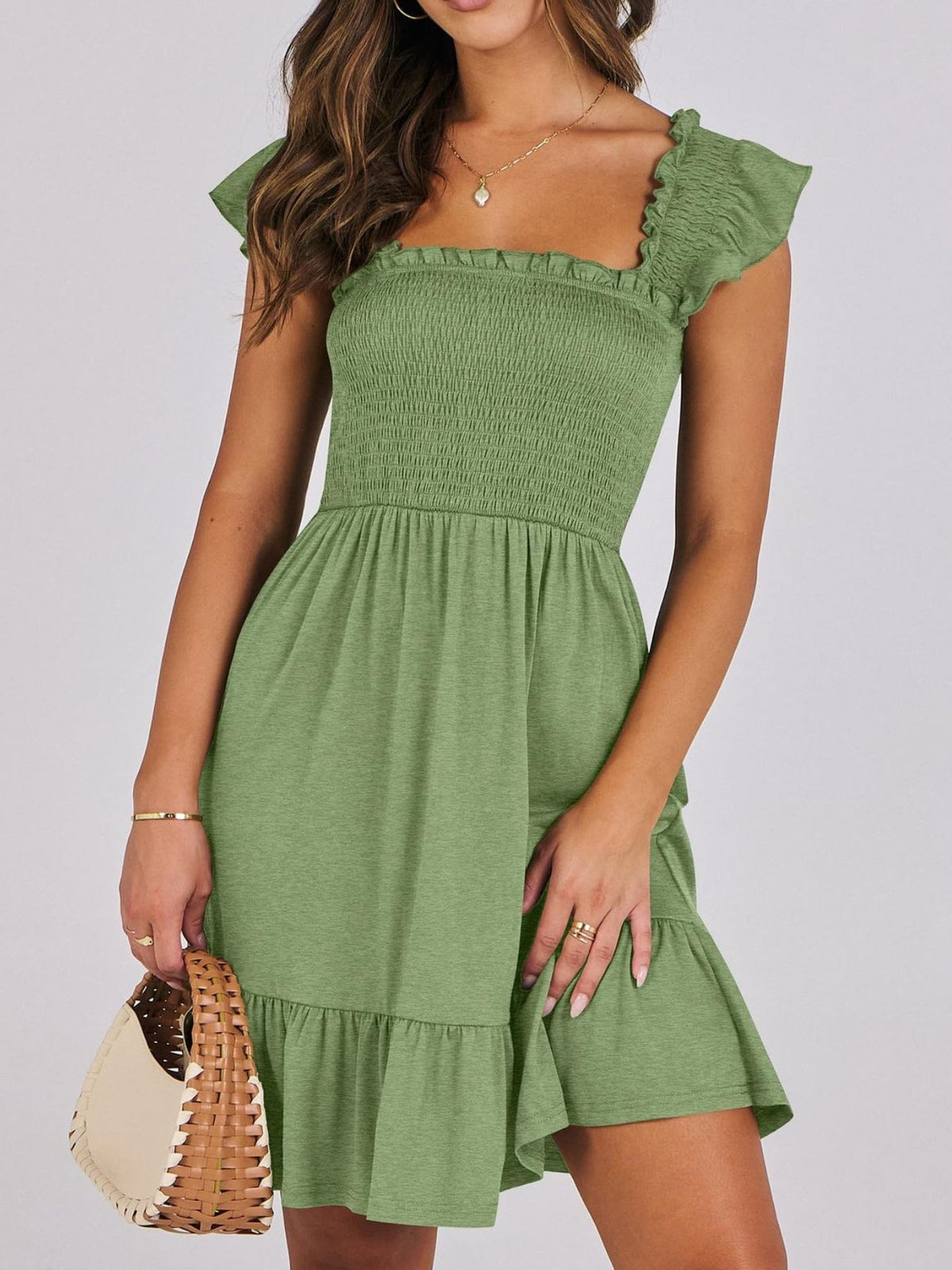 Sage green smocked ruffle hem mini dress by Trendsi, featuring a fitted bodice and playful ruffle details at the hem.