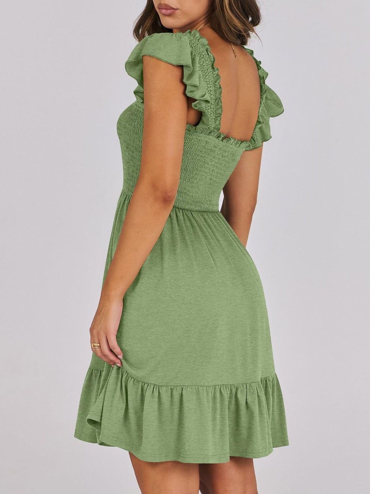 Sage green smocked ruffle hem mini dress by Trendsi, featuring a fitted bodice, ruffled hem, and adjustable straps.