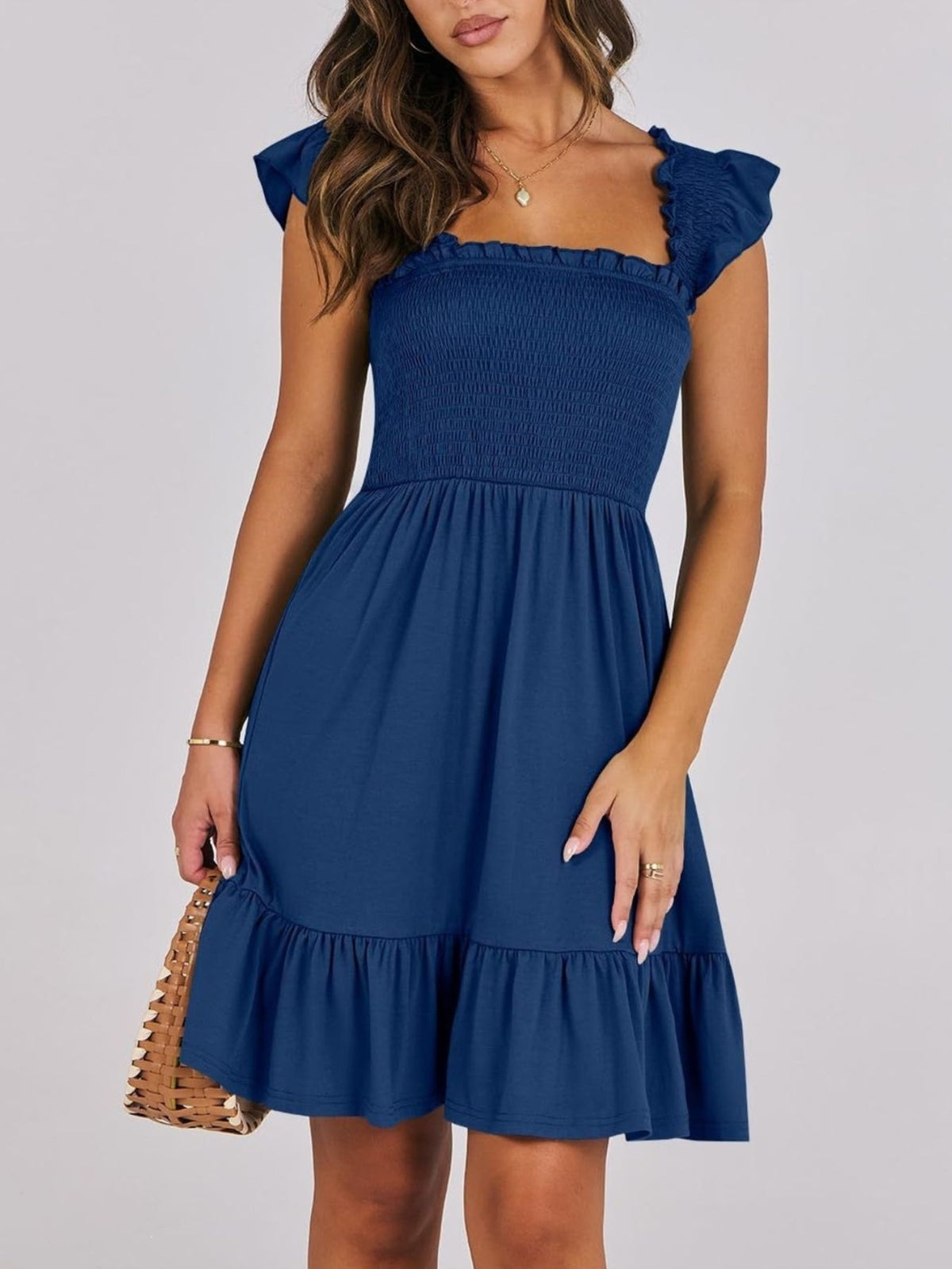 Sage green smocked ruffle hem mini dress by Trendsi, showcasing a fitted bodice, ruffled hem, and lightweight fabric.