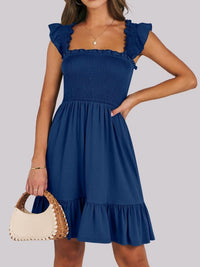 Sage green smocked ruffle hem mini dress by Trendsi featuring a fitted bodice and playful ruffle details.