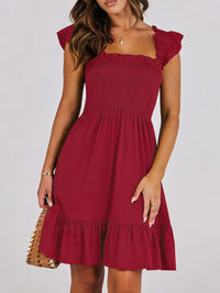 Sage green smocked ruffle hem mini dress by Trendsi, featuring a fitted bodice and flowy ruffle details at the hem.