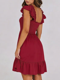 Sage green smocked ruffle hem mini dress by Trendsi, featuring a fitted bodice, ruffled hem, and sleeveless design.
